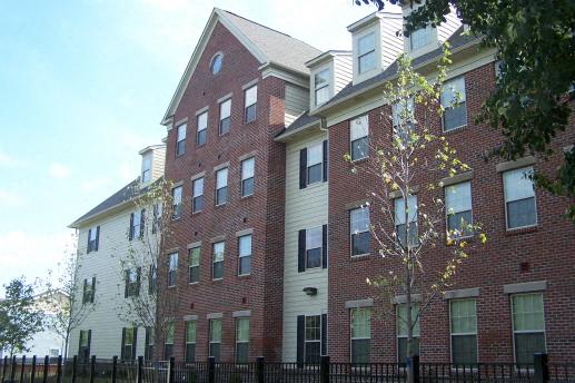 a large brick building with a fence in front of it